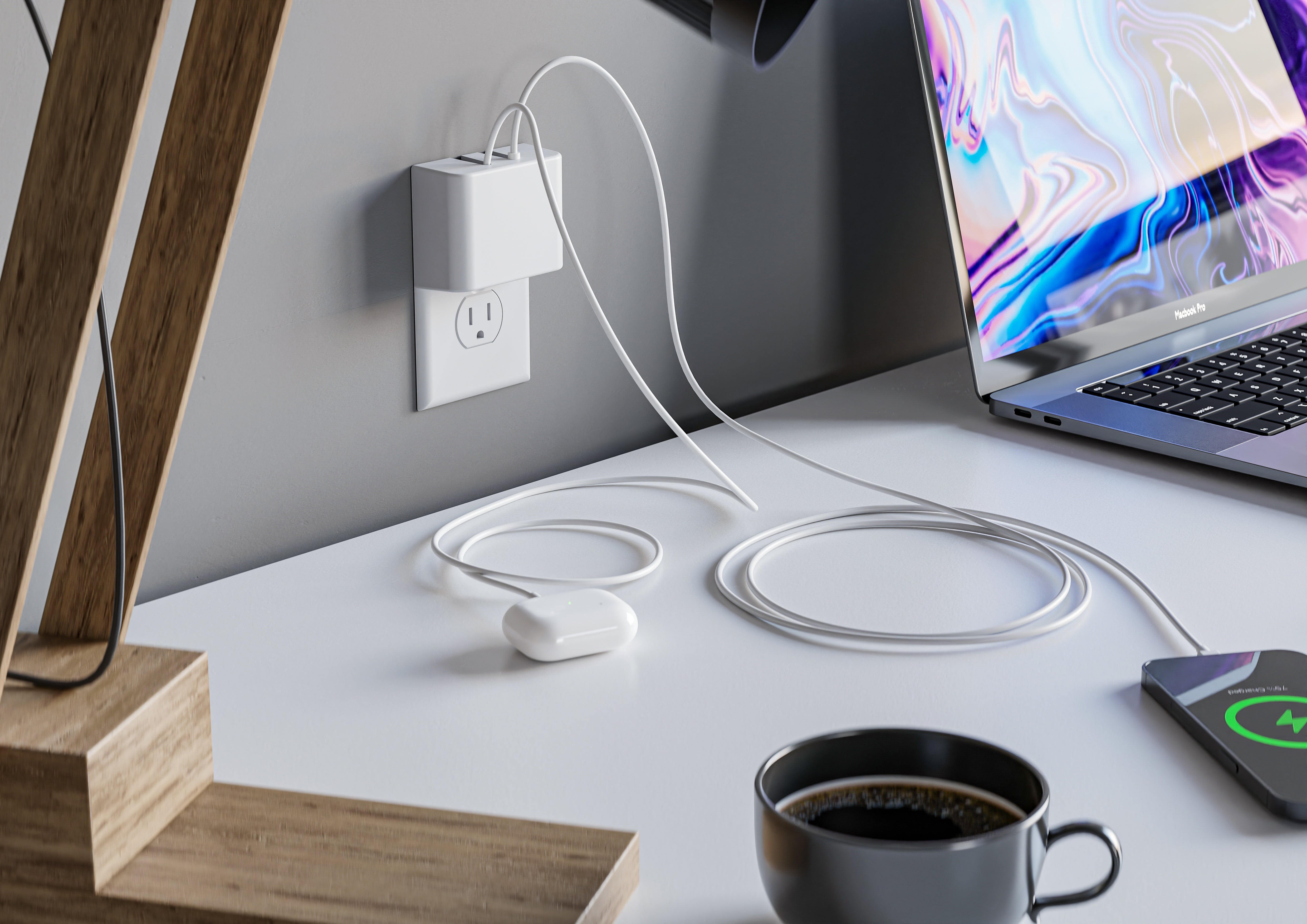 This image shows a minimalist workspace featuring the Permaplug Charger Lock securely plugged into a wall outlet. It has two cables attached, one charging a smartphone wirelessly on the desk and the other connected to a pair of wireless headphones. A MacBook Pro is also on the desk, alongside a cup of coffee and a wooden desk lamp, highlighting a clean and organized tech setup.